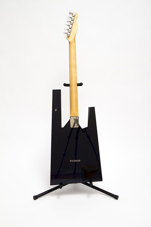 The back of the baratone Opponent on a guitar stand