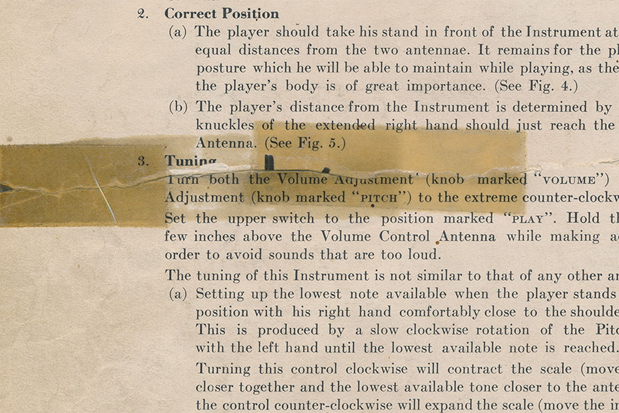 Original Owners Manual page with rip and aged tape